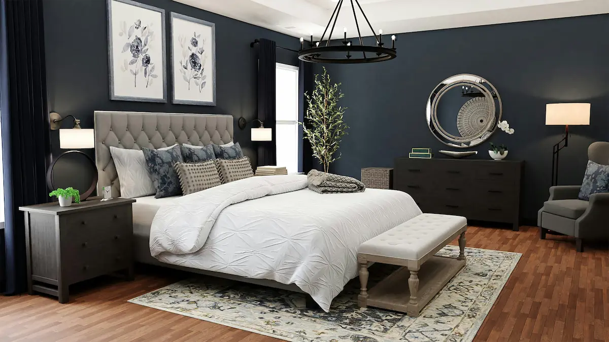 Elegant bedroom with deep blue walls, gray tufted headboard bed, white bedding and matching dark wood furniture